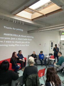 In this picture, Marta Vella is opening the event conversation. Around her the panellists, Ted Evans, Ella Glendining and Julie McNamara and the audience.
